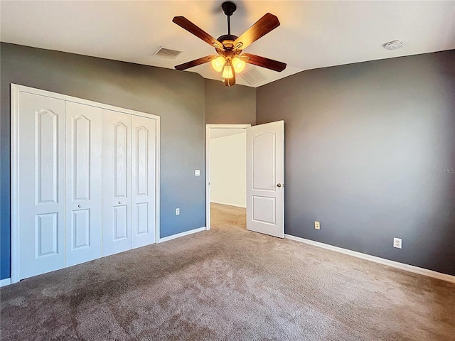 unfurnished bedroom with a closet, ceiling fan, lofted ceiling, and light colored carpet