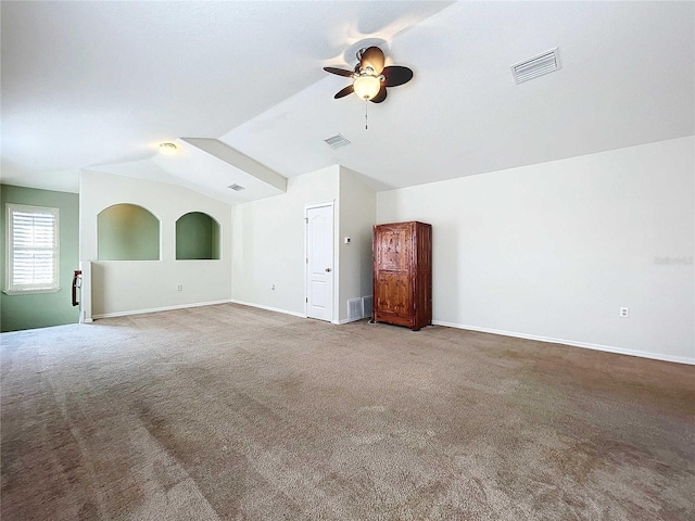 interior space featuring lofted ceiling, carpet floors, and ceiling fan