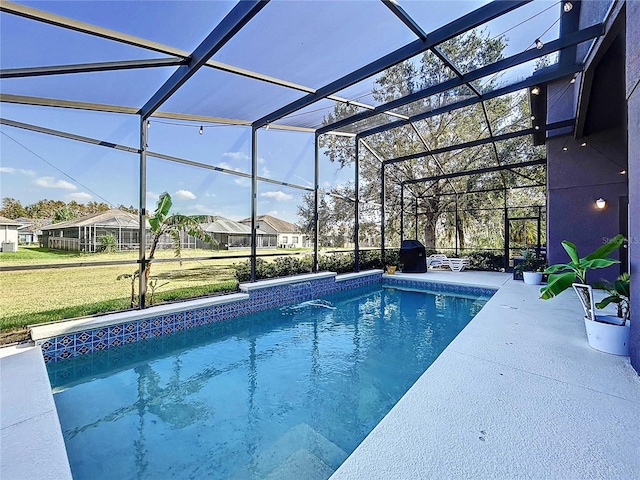 view of pool featuring a patio, pool water feature, a lanai, and a yard