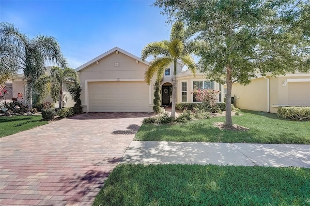 single story home featuring a front yard and a garage