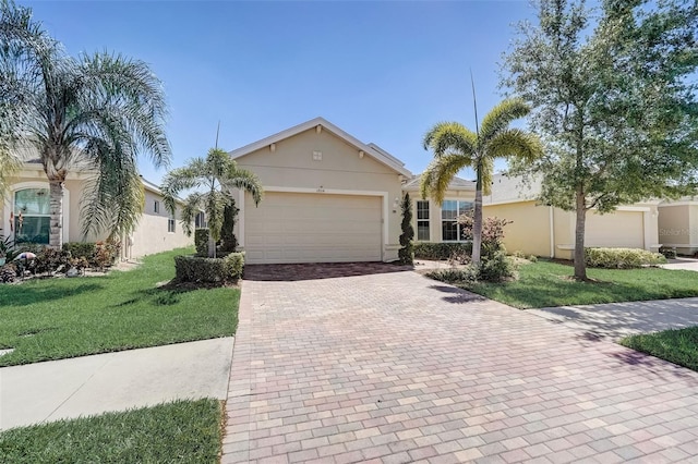 ranch-style house with a garage and a front lawn