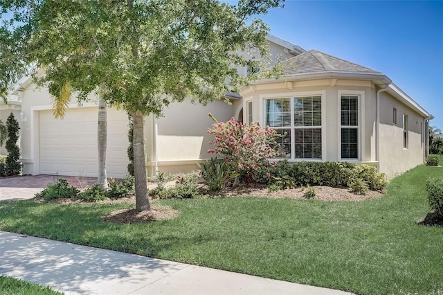 view of property exterior featuring a yard and a garage