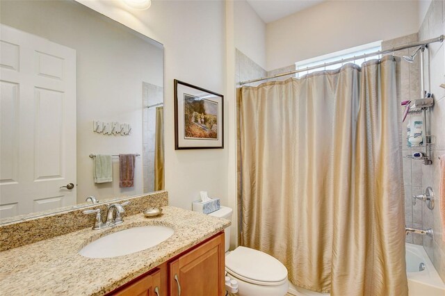 full bathroom featuring toilet, shower / bath combo, and vanity