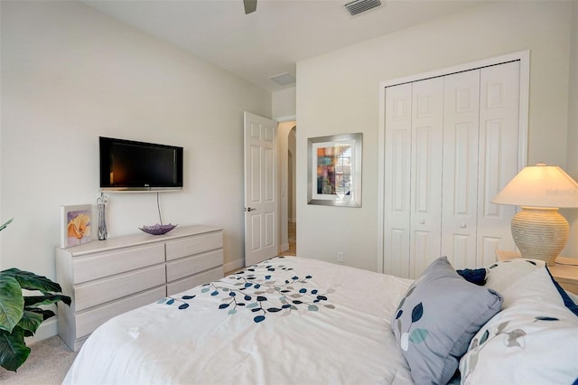 bedroom featuring light carpet, a closet, and ceiling fan