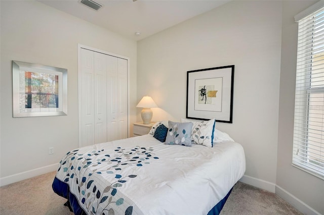 bedroom with a closet and light colored carpet