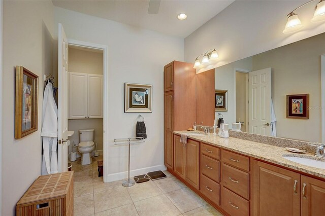 bathroom with vanity, toilet, and tile patterned flooring