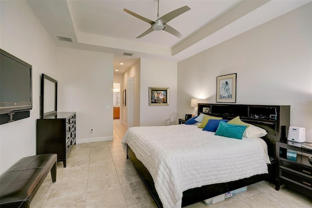 tiled bedroom featuring a tray ceiling and ceiling fan