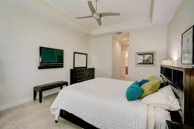 tiled bedroom featuring a tray ceiling and ceiling fan