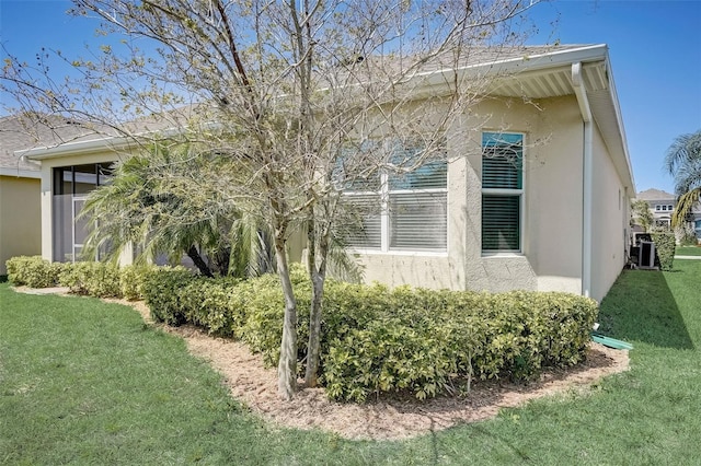 view of side of home with a yard