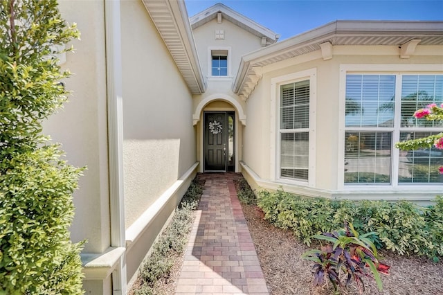 1804 Pacific Dunes Dr, Sun City Center, FL 33573 - doorway to property featuring stucco siding