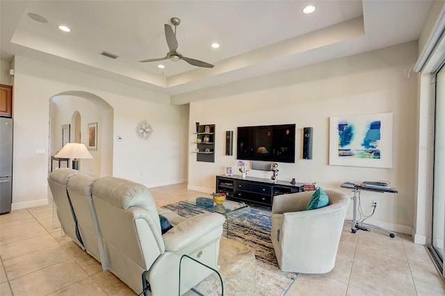 1804 Pacific Dunes Dr, Sun City Center, FL 33573 - living room with a tray ceiling, light tile patterned flooring, a ceiling fan, recessed lighting, and arched walkways