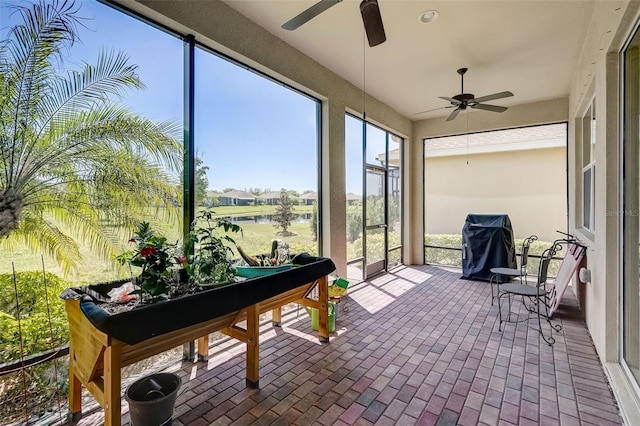 1804 Pacific Dunes Dr, Sun City Center, FL 33573 - sunroom with ceiling fan, a water view, and brick patterned flooring