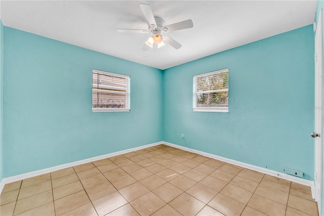 tiled empty room featuring ceiling fan