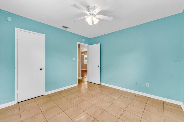 spare room featuring ceiling fan and light tile patterned flooring