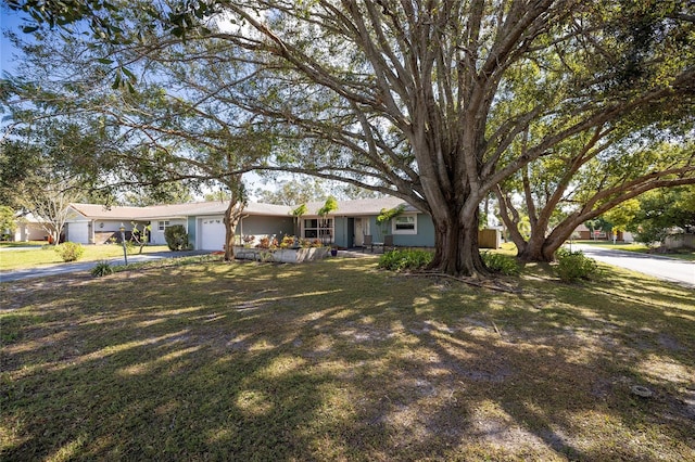 ranch-style house with a garage and a front yard