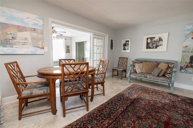 dining room with a textured ceiling and ceiling fan