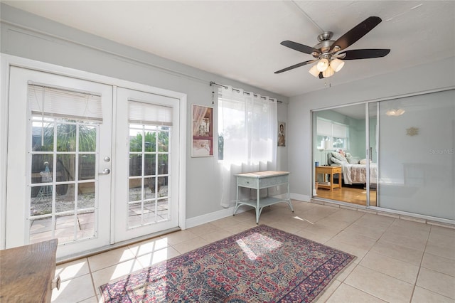 doorway featuring ceiling fan, light tile patterned floors, and french doors