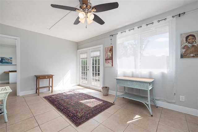 doorway featuring french doors, light tile patterned floors, and ceiling fan