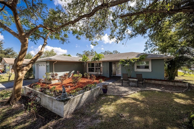 ranch-style house with a garage and a front yard