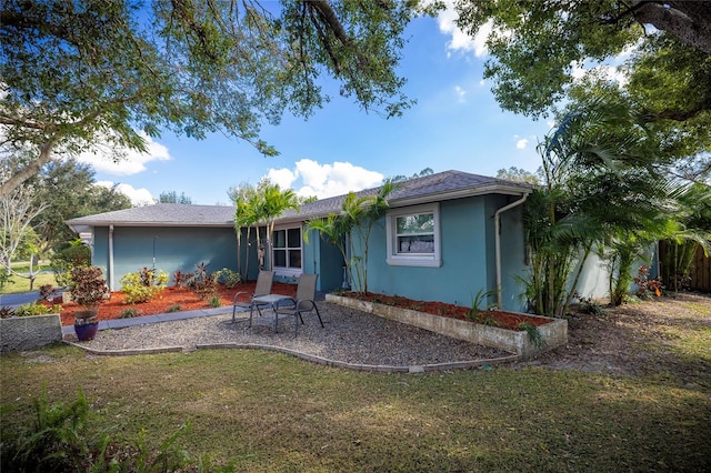 rear view of house featuring a lawn