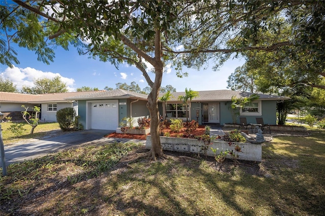 single story home with a garage and a front yard