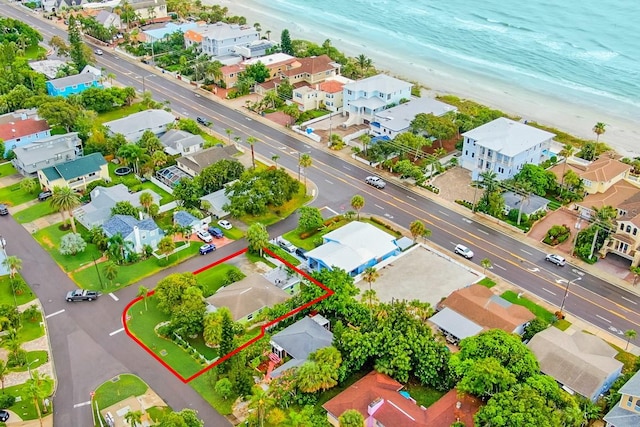 birds eye view of property featuring a water view and a beach view