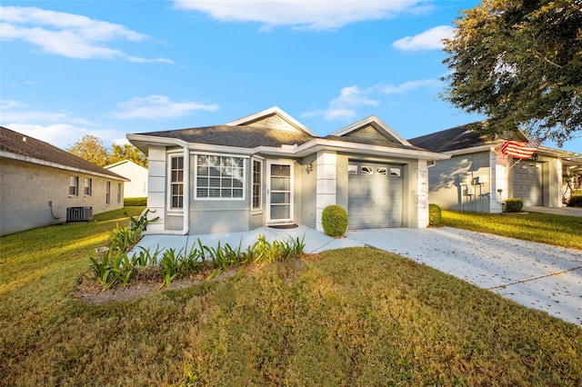 ranch-style home with concrete driveway, an attached garage, a front lawn, and central air condition unit