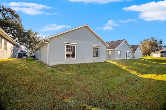 rear view of property featuring a lawn