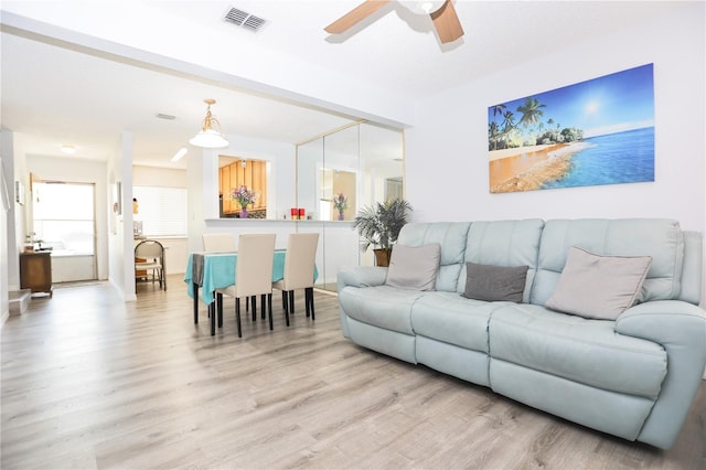 living room with light hardwood / wood-style floors and ceiling fan