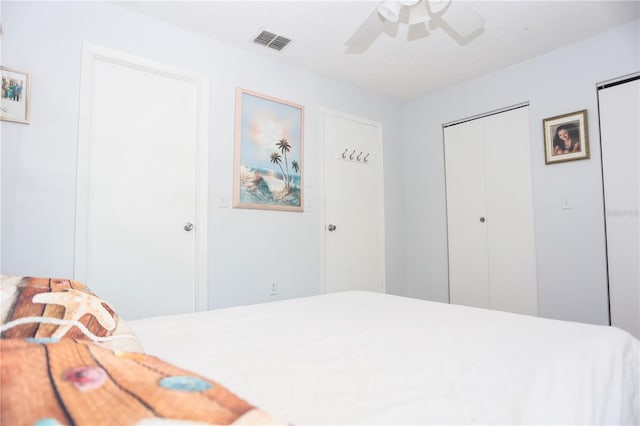 bedroom with ceiling fan and a textured ceiling