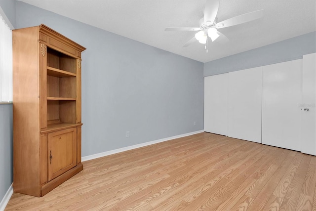 unfurnished bedroom featuring ceiling fan and light wood-type flooring