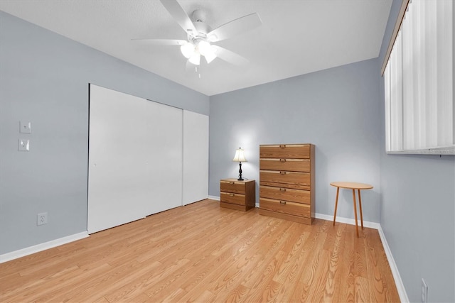 unfurnished bedroom with light hardwood / wood-style floors, a closet, and ceiling fan