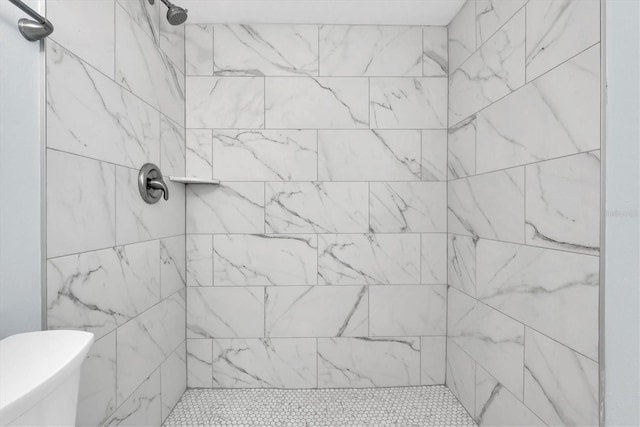 bathroom featuring toilet and tiled shower