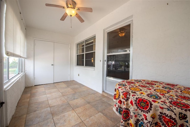 sunroom / solarium featuring ceiling fan