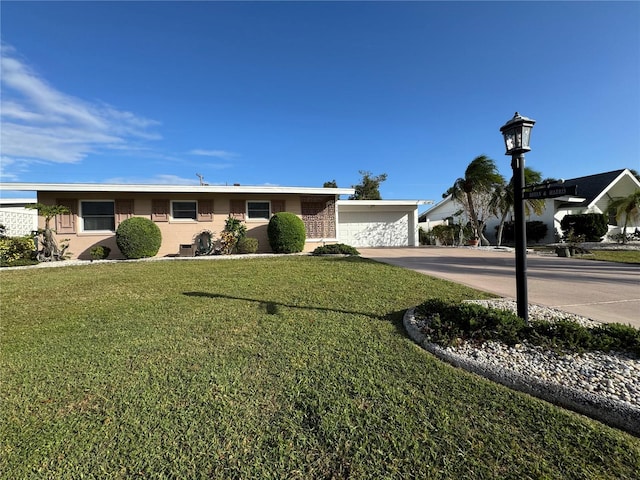 ranch-style home with a front yard and a garage