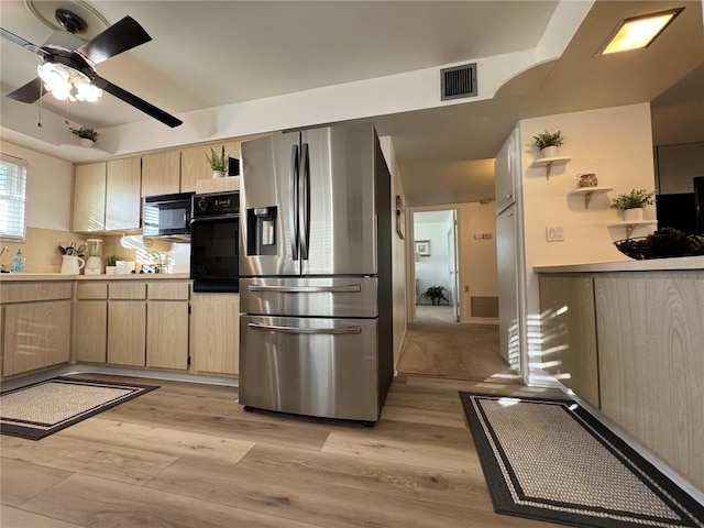 kitchen with decorative backsplash, light brown cabinets, light hardwood / wood-style flooring, black appliances, and ceiling fan