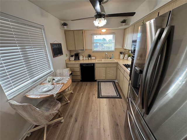 kitchen with decorative backsplash, black dishwasher, light wood-type flooring, stainless steel refrigerator with ice dispenser, and sink