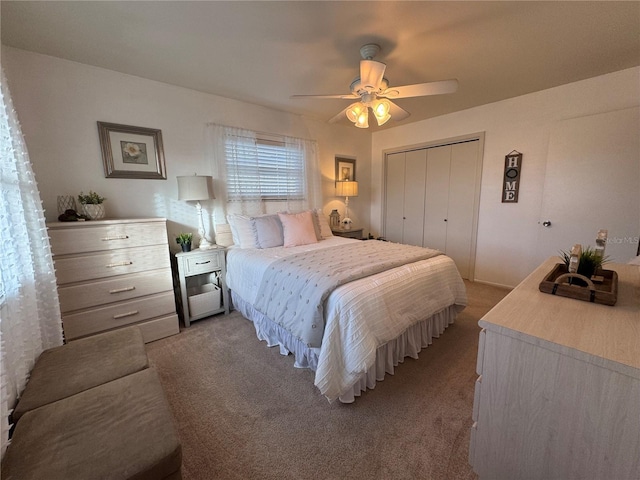 carpeted bedroom with a closet and ceiling fan