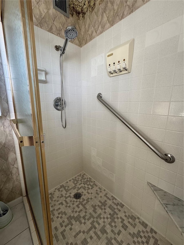 bathroom featuring a shower with door and tile patterned flooring