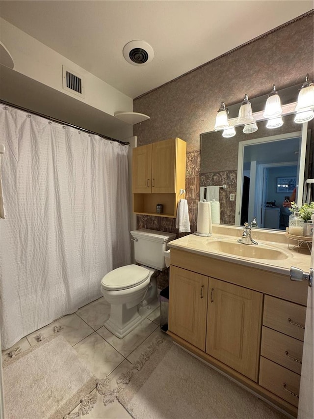 bathroom featuring vanity, toilet, and a shower with shower curtain