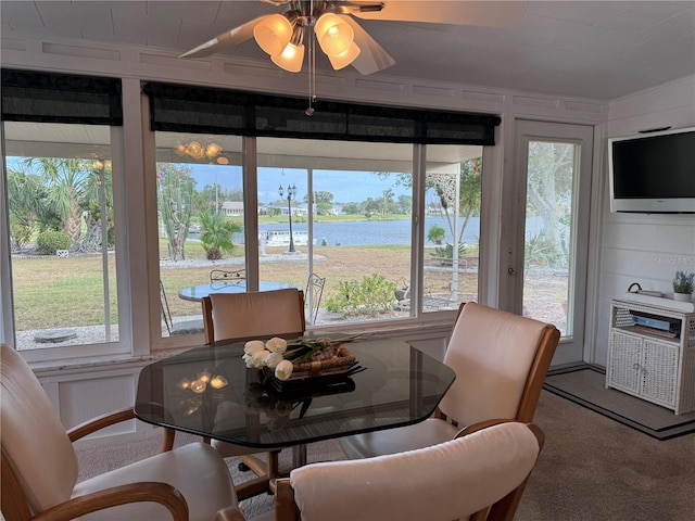 carpeted dining space featuring ceiling fan and a wealth of natural light