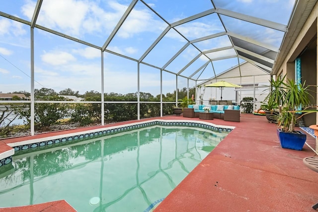 view of pool with glass enclosure, an outdoor living space, and a patio