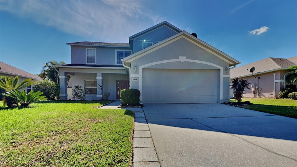 view of front of property with a front lawn and a garage