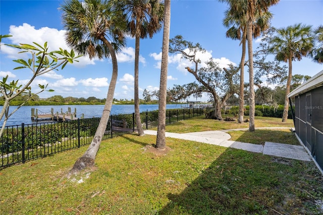 view of yard featuring a dock and a water view