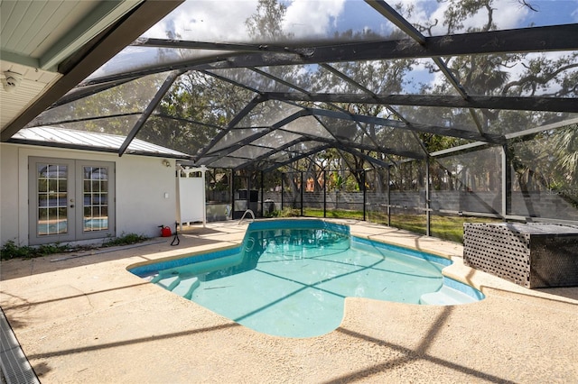 view of swimming pool featuring a patio area, french doors, and a lanai