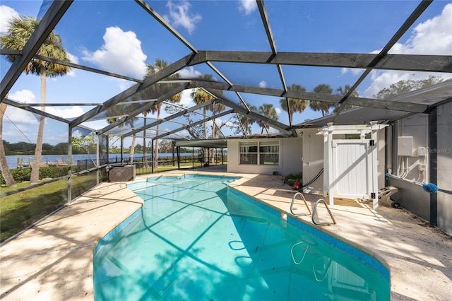 view of swimming pool with a patio and glass enclosure