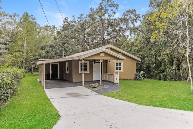 view of front of house with a front lawn and a carport