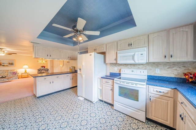 kitchen with decorative backsplash, a tray ceiling, crown molding, white appliances, and ceiling fan