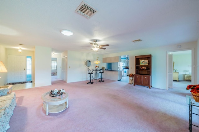 carpeted living room featuring ceiling fan