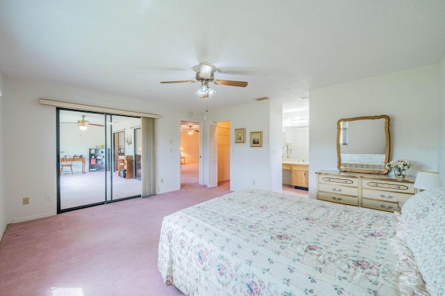 carpeted bedroom featuring a textured ceiling, ensuite bathroom, and ceiling fan